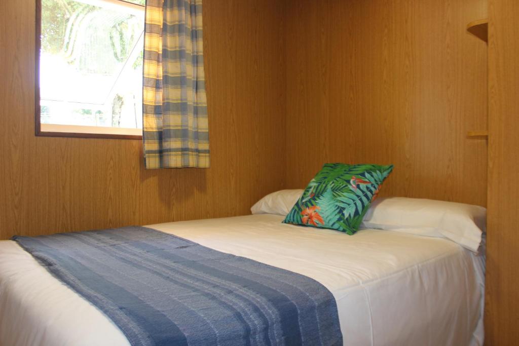 A bed or beds in a room at Camping As Cancelas