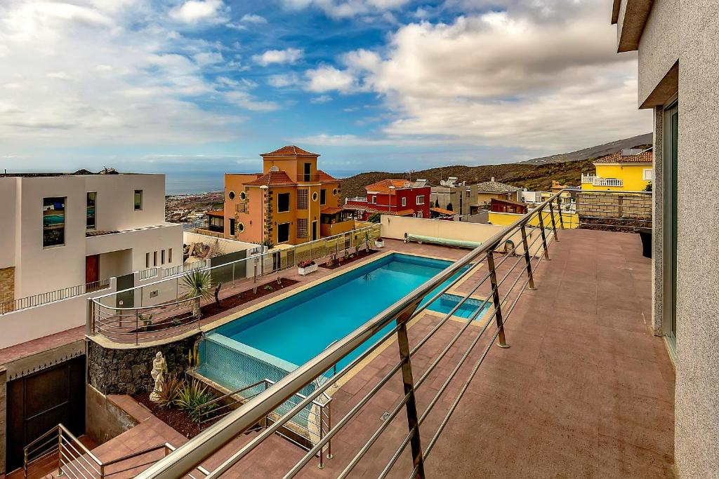 a balcony with a swimming pool on top of a building at Villa Josefina in Adeje