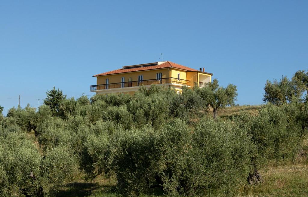 a house on top of a hill with trees at Residence Borgo Offida in Offida
