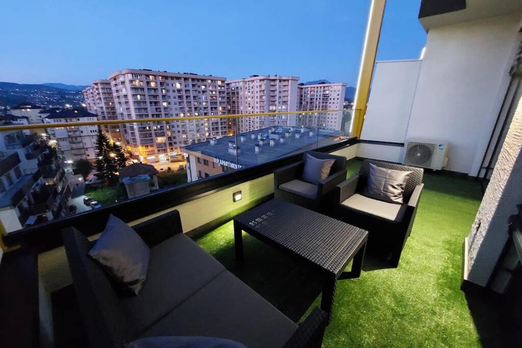 einen Balkon mit Sofas und einem Tisch auf einem Gebäude in der Unterkunft Luxury Penthouse Sarajevo in Sarajevo