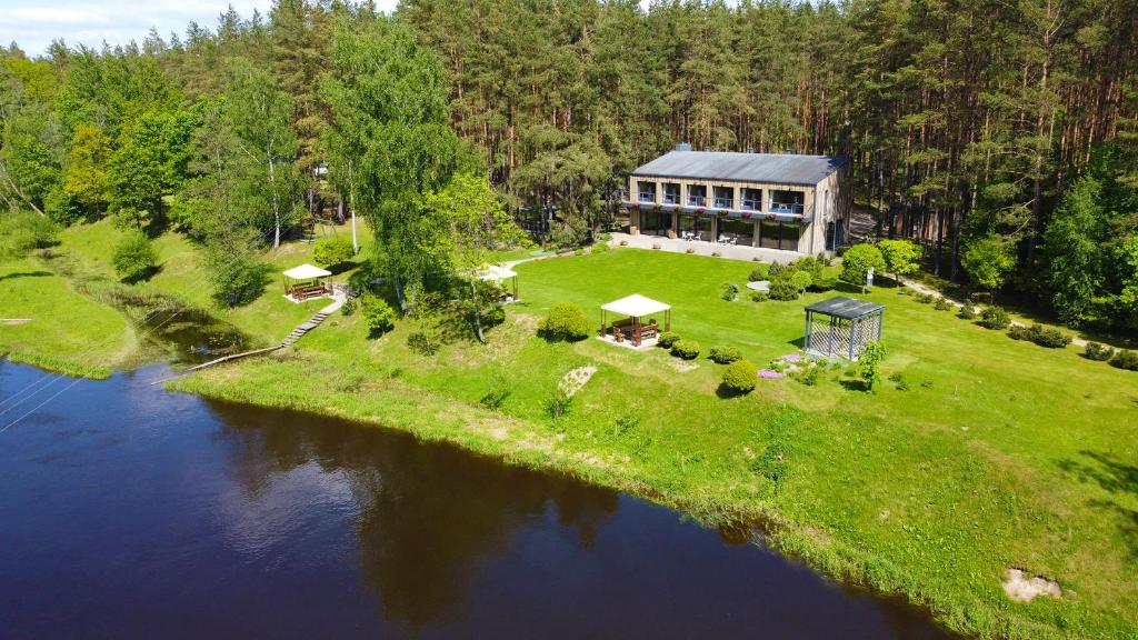 an aerial view of a house next to a river at Pušų takas in Andrioniškis