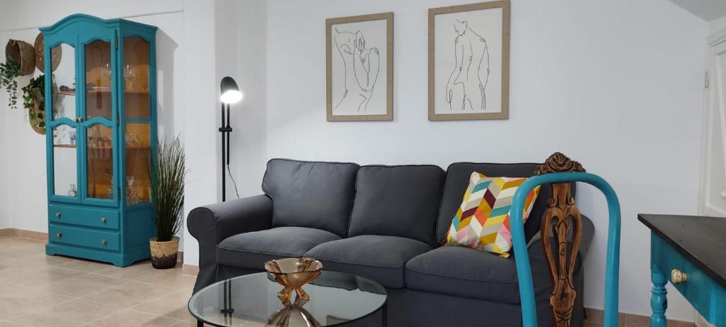 a living room with a blue couch and a glass table at Casa Tío Luis in Santa Cruz de la Palma