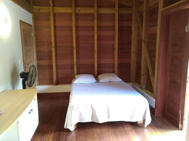 Postel nebo postele na pokoji v ubytování Un cosy sous le vent