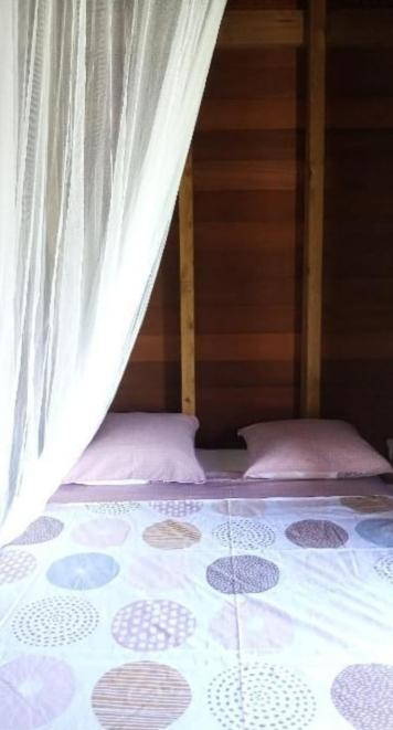 Postel nebo postele na pokoji v ubytování Un cosy sous le vent