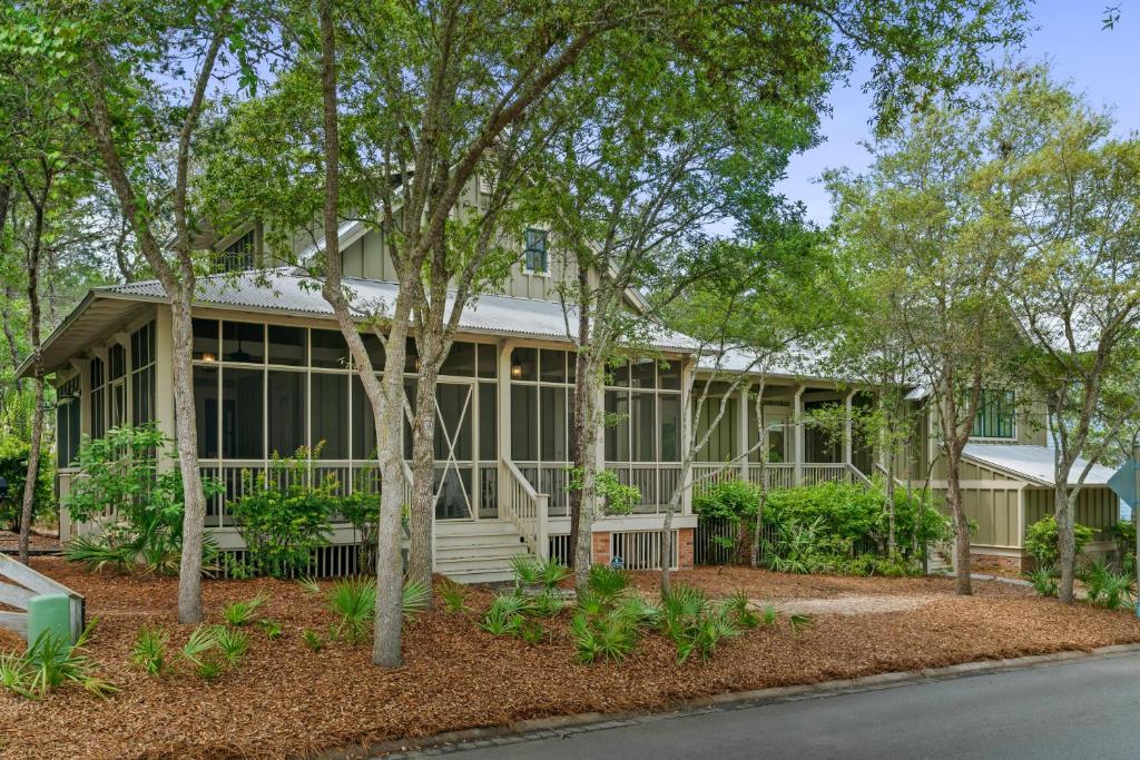 a house with trees in front of it at 13 Lake District Lane in Santa Rosa Beach