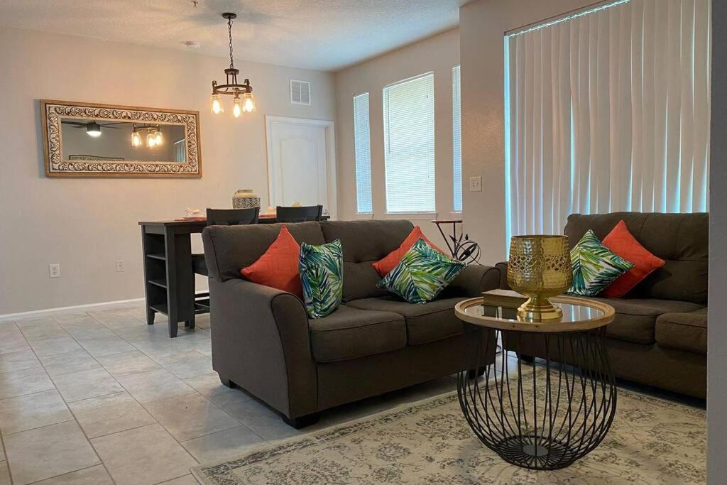 a living room with a couch and a table at LUXURY and VINTAGE space to enjoy your vacation!! in Kissimmee