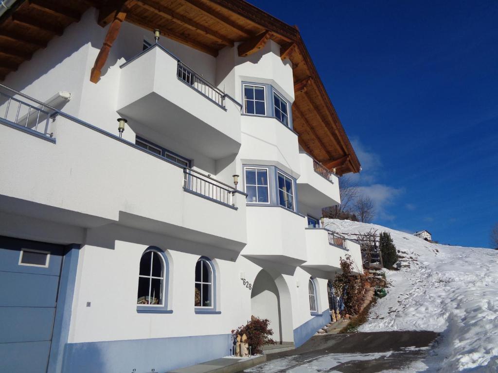 a white building on a snow covered hill at Haus Siegele Marco in Kappl
