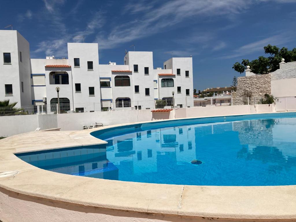 a large swimming pool in front of a building at Casa As Estrelas in Carvoeiro