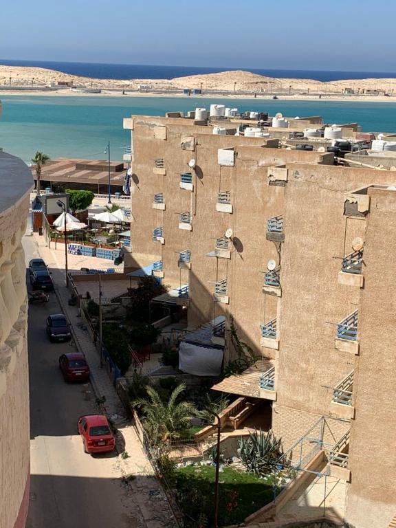 an aerial view of a building with a parking lot at Ashour Tower Ramy Abdulla For Families only in Marsa Matruh