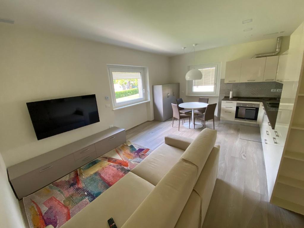 a living room with a couch and a tv and a table at Chaligne Suite in Aosta