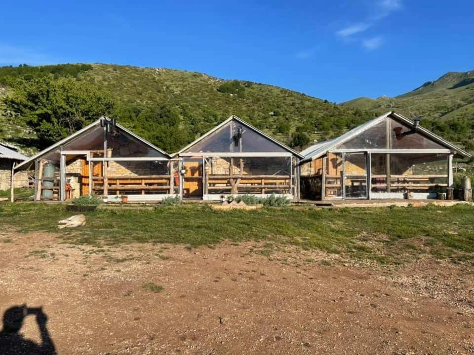 a person taking a picture of a house at Camping Cajupi in Gjirokastër