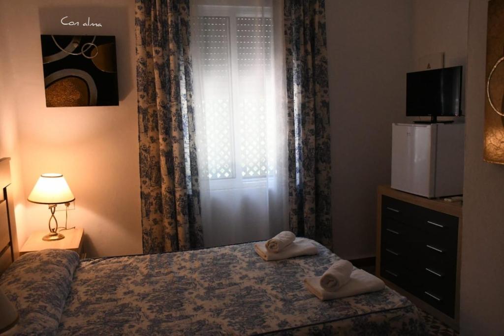 Łóżko lub łóżka w pokoju w obiekcie Hostal Costa de la Luz