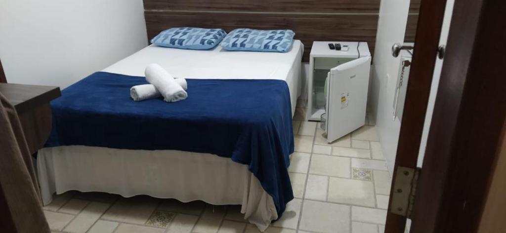 a bedroom with a bed with two white towels on it at Pousada Barrancas in Piranhas