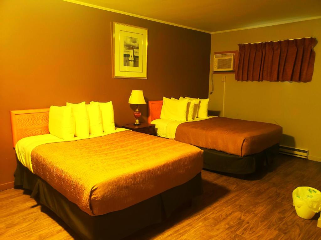 a hotel room with two beds in a room at Wildwood Motel in Shelburne