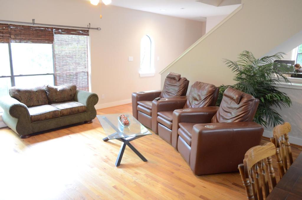 a living room with couches and a coffee table at Modern B & B in Houston