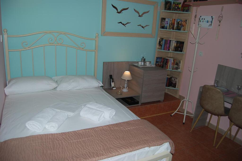 1 dormitorio con 1 cama con toallas en LUXURY TRADITIONAL ROOM The Small Bookstore en Kyllini