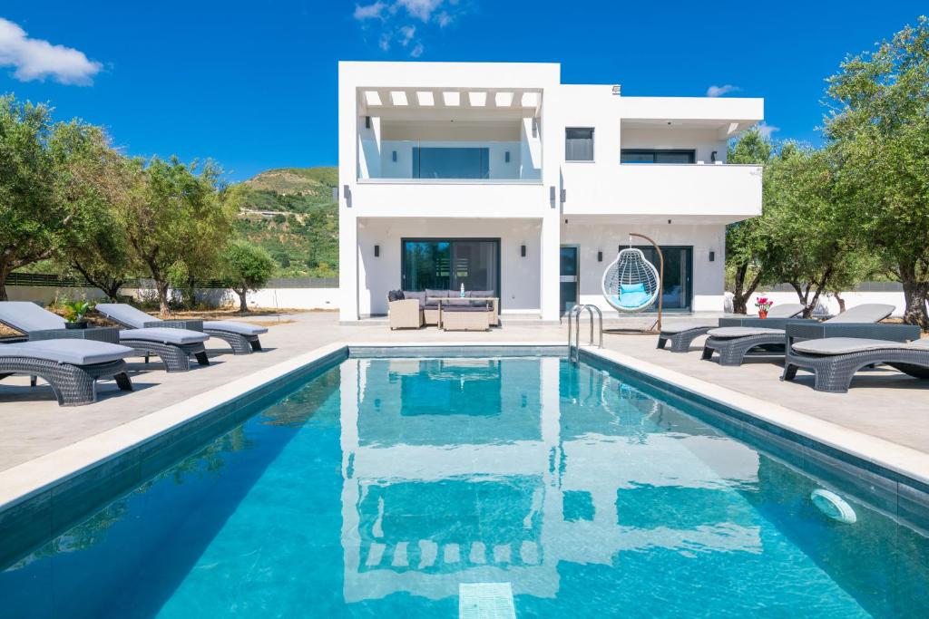 uma villa com uma piscina e uma casa em Grande Amore Villa em Pandokrátor