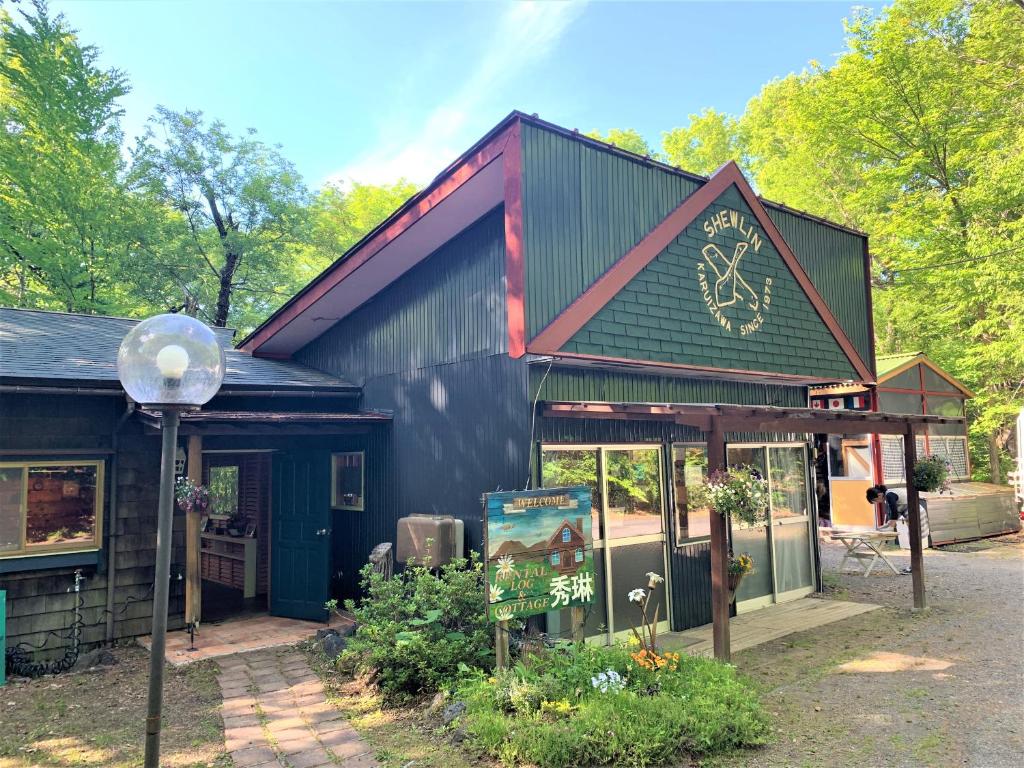 a black and red building with a sign on it at Shurin in Tsumagoi