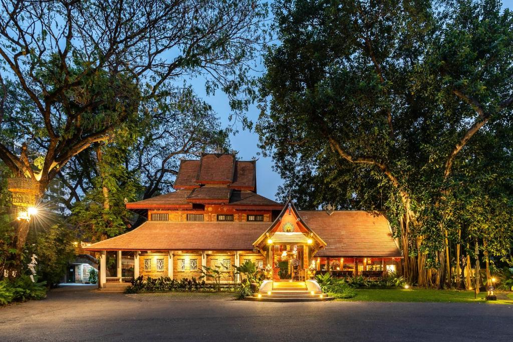 a large house with lights on the front of it at Yaang Come Village Hotel - SHA Extra Plus in Chiang Mai