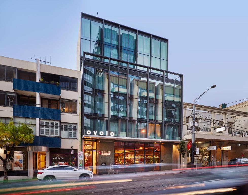 a building on a city street with a car in front at Ovolo South Yarra in Melbourne