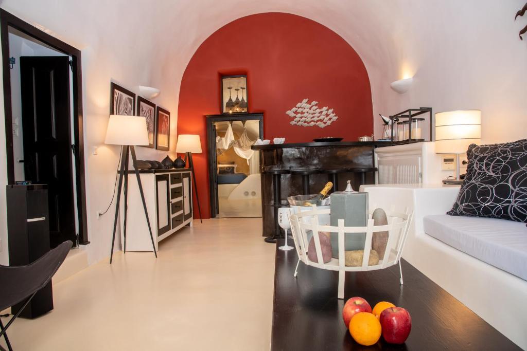 a living room with a couch and a table at Villa Orpheus Santorini in Megalokhori