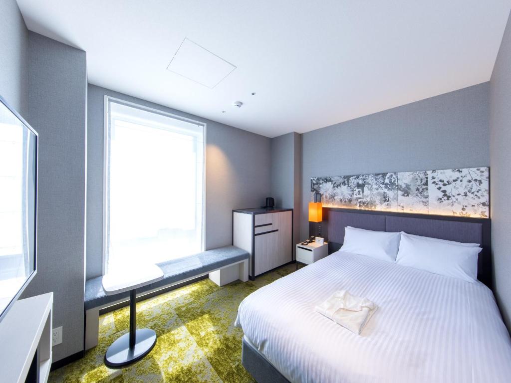 Postel nebo postele na pokoji v ubytování Hotel Forza Kyoto Shijo Kawaramachi
