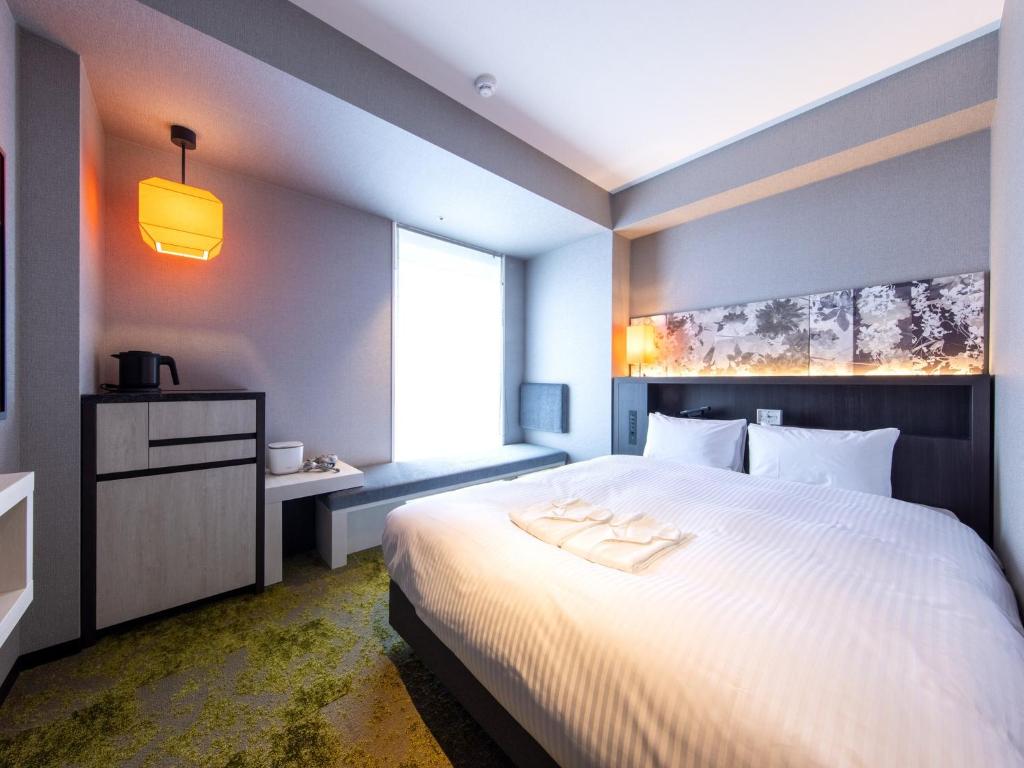 Postel nebo postele na pokoji v ubytování Hotel Forza Kyoto Shijo Kawaramachi