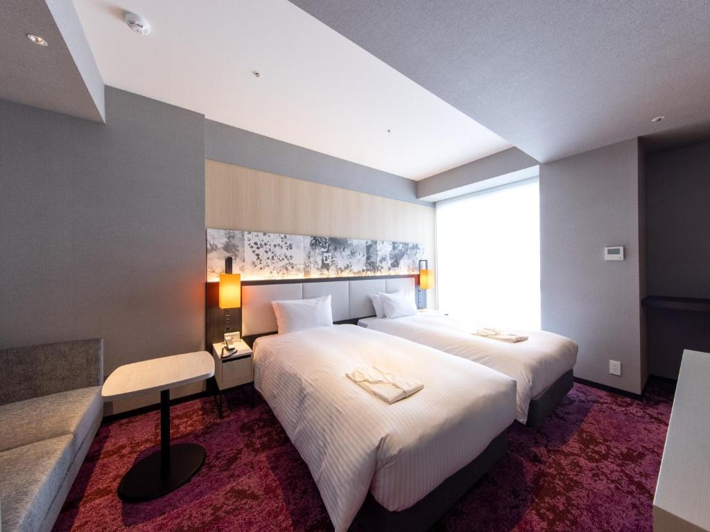 Postel nebo postele na pokoji v ubytování Hotel Forza Kyoto Shijo Kawaramachi