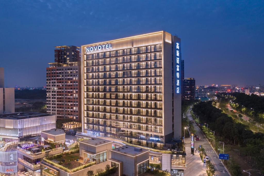 a hotel building with a sign on top of it at Novotel Dongguan Songshan in Dongguan