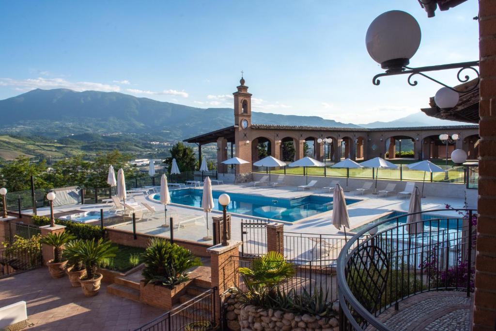 a resort with a swimming pool and a building at Il Poggio in Ascoli Piceno