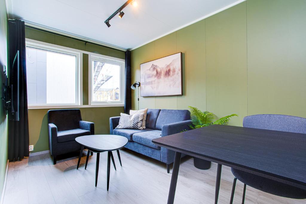 a living room with a couch and a table at Easy Home Apartments in Hammerfest