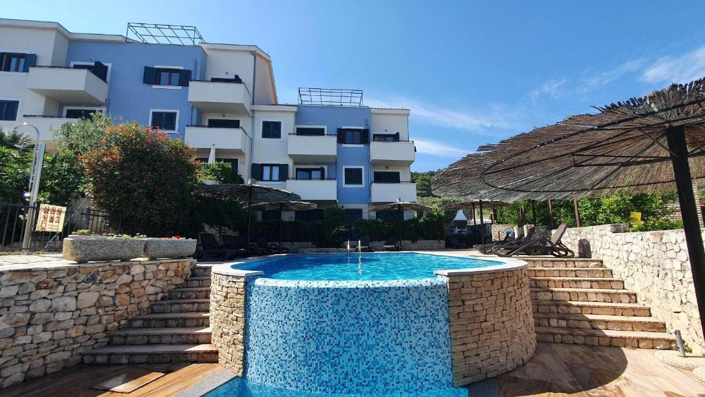 a swimming pool in front of a building at SeaSight Apartment - Ciovo Island in Slatine