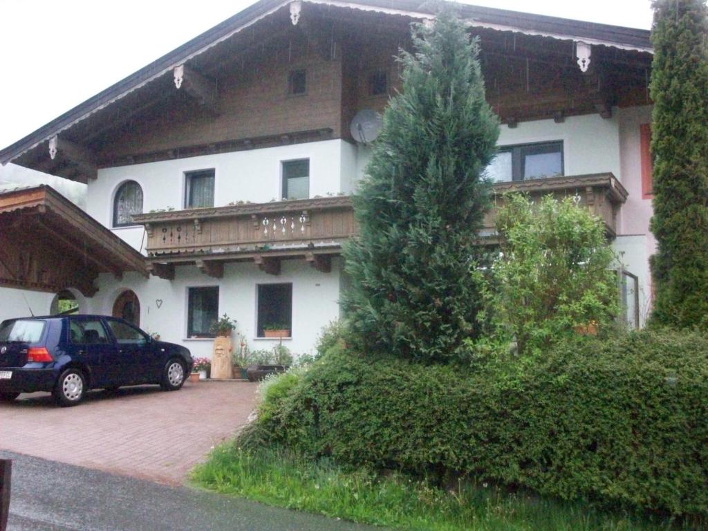 a car parked in front of a house at Appartements Renate in Kirchberg in Tirol