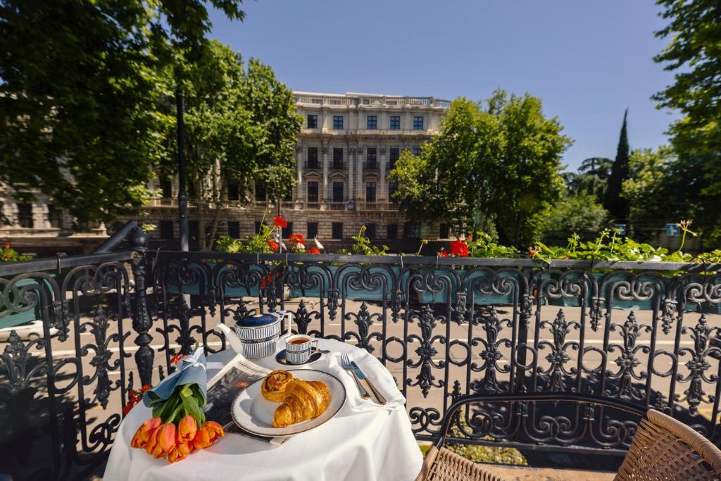 a table with a plate of food on top at Octava Boutique Hotel in Tbilisi City