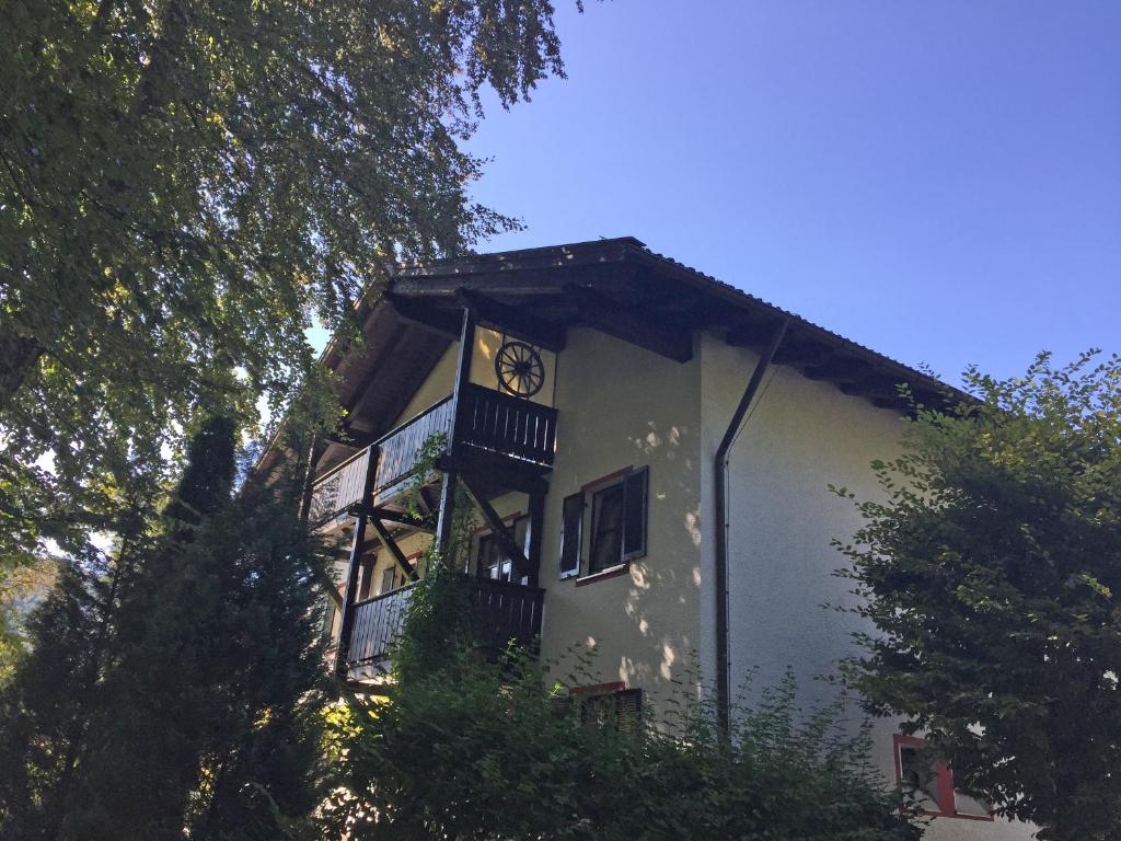 a building with a clock on the side of it at Ferienwohnung Haus Kampenwand Löhr in Aschau im Chiemgau