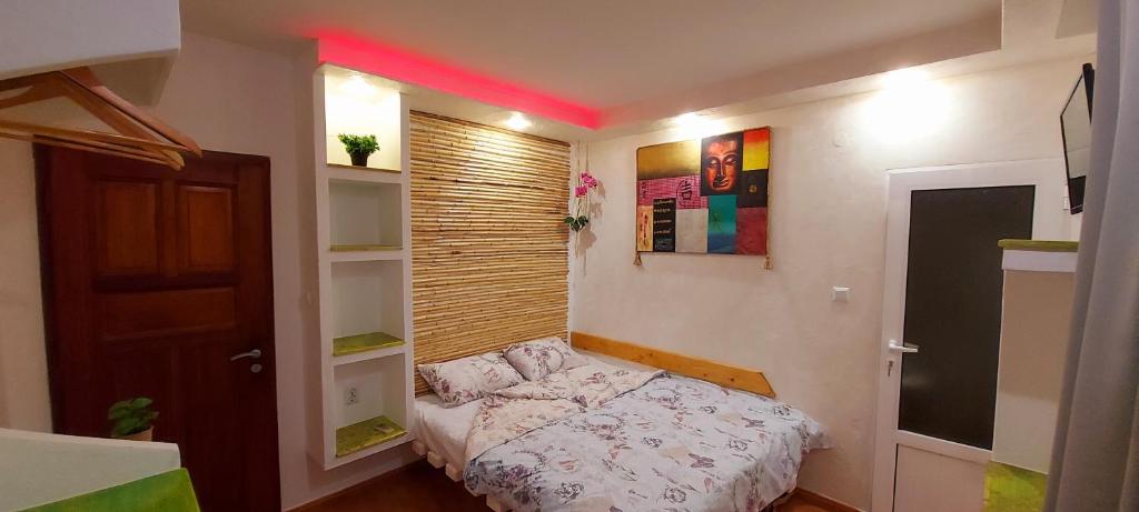 a small bedroom with a bed in a room at Sentosa ROOM in Nesebar