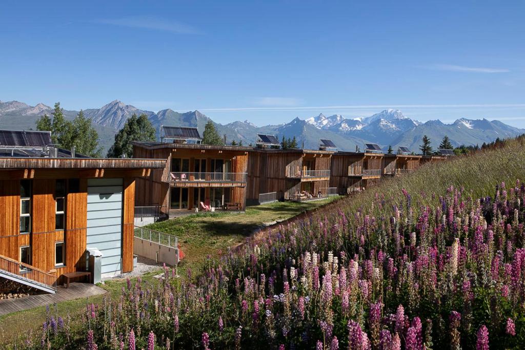 
a scenic view of a small town with a mountain range at L'Aiguille Grive Chalets Hotel in Arc 1800
