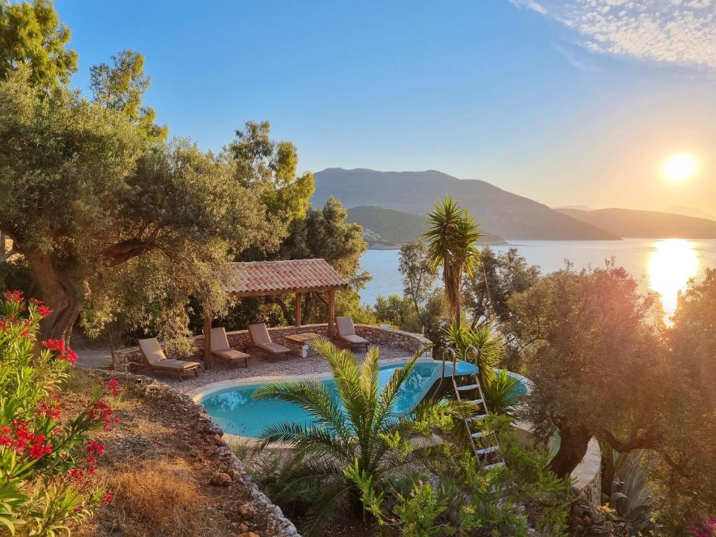 a resort with a pool and a view of the water at Villa Nautique - Waterfront in Sivota
