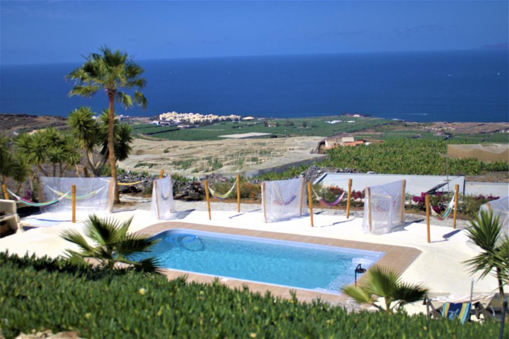 a swimming pool with a view of the ocean at Finca Gaia La Segunda in Guía de Isora