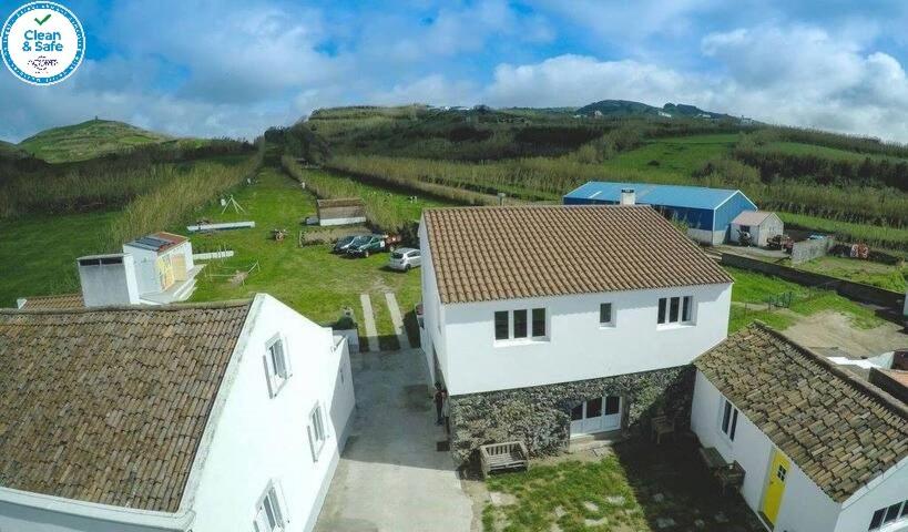 an aerial view of two white houses and a field at Casa das Camarinhas RAAL 542- casa partilhada in Ginetes