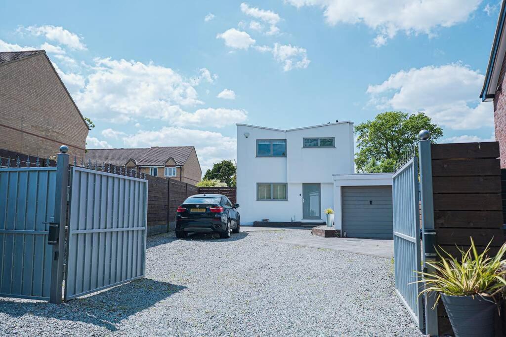 a car parked in the driveway of a house at Modern Private Gated Luxury Home Getaway in Elmers End