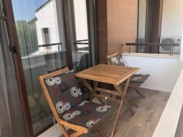 a balcony with a table and chairs with owls on them at Apartment FREEDOM in Shkorpilovtsi