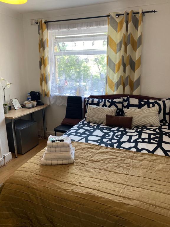 a bedroom with a large bed and a window at Amber Guest House in London
