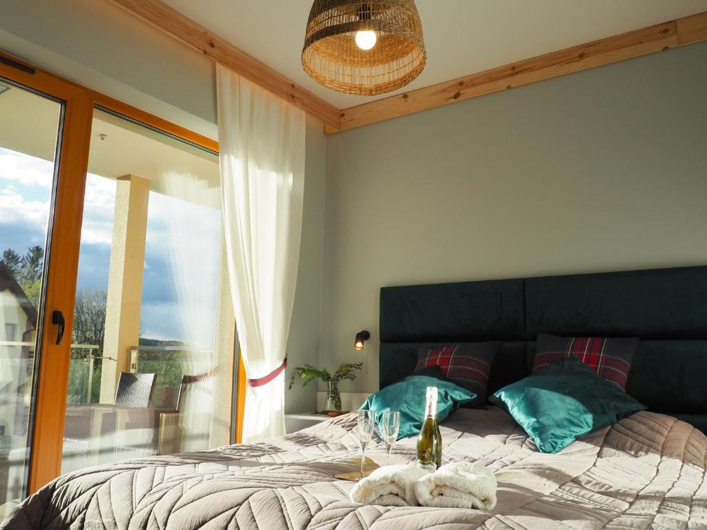 a bedroom with a bed and a large window at Apartament MONTANA in Karpacz