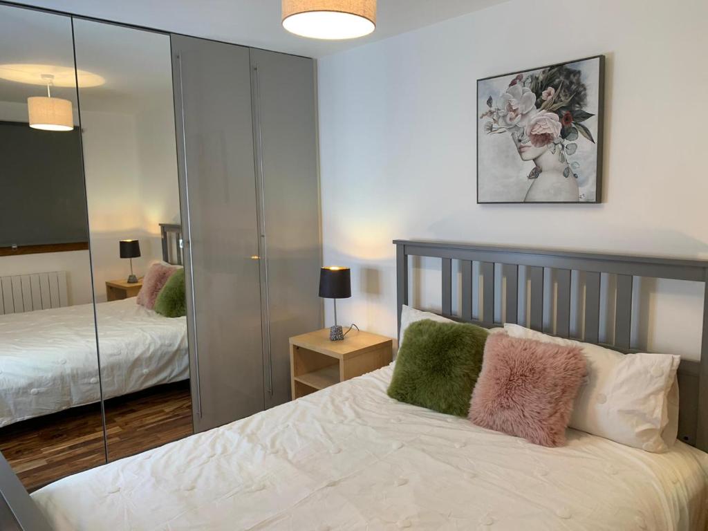a bedroom with a bed and a mirror at Causewayside in Edinburgh