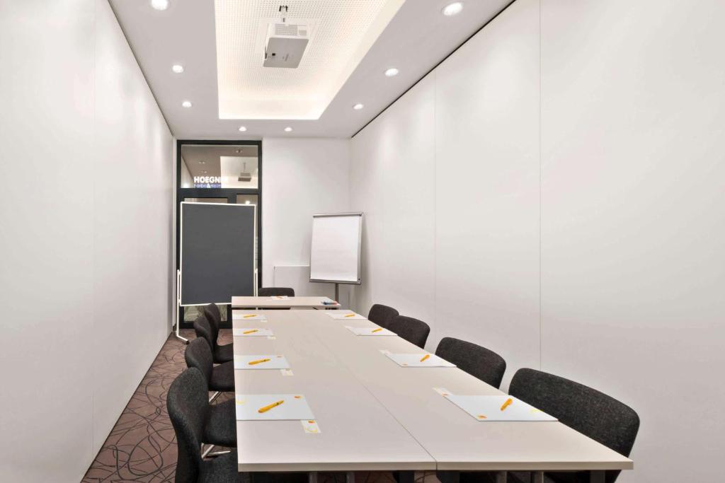 a conference room with a long table and chairs at Super 8 by Wyndham Munich City North in Munich