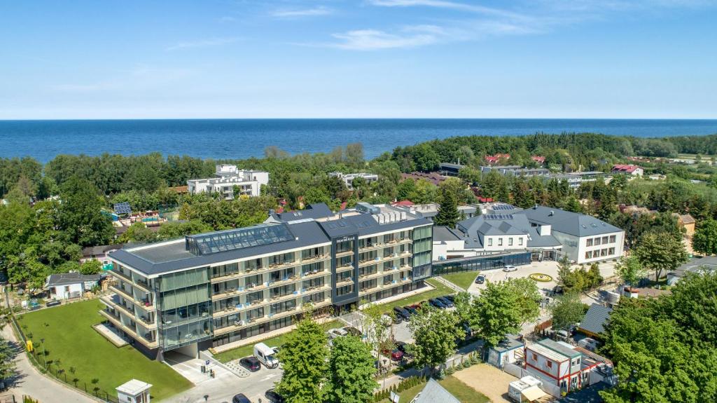 an aerial view of a building with the ocean in the background at Imperiall Resort & MediSpa in Ustronie Morskie