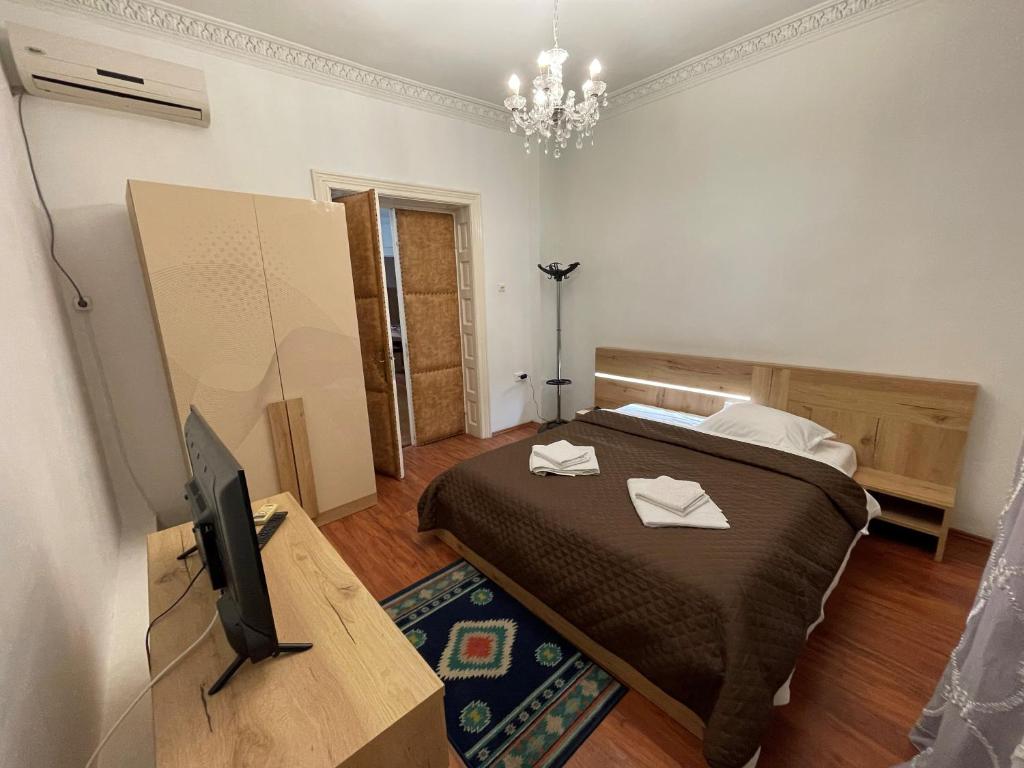 a bedroom with a bed and a tv on a table at Villa Dumbrava Rosie in Constanţa