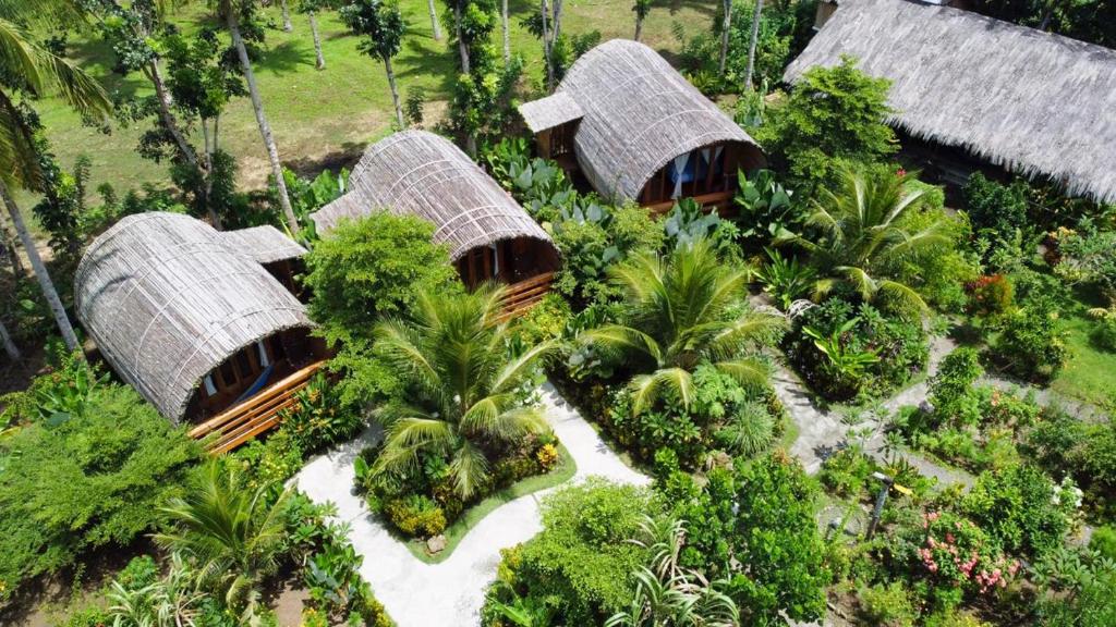 an overhead view of three bamboo huts in a forest at Lagoona Beach Bungalows - Eco Resort Batukaras in Batukaras