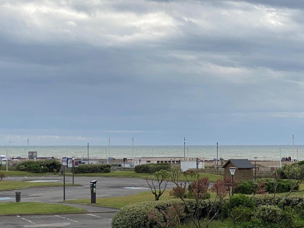 un estacionamiento con el océano en el fondo en Roi Soleil en Le Touquet-Paris-Plage